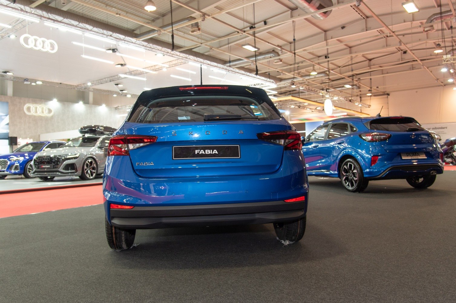 Rear view of blue hatchback with sharp taillights and sleek hatch design