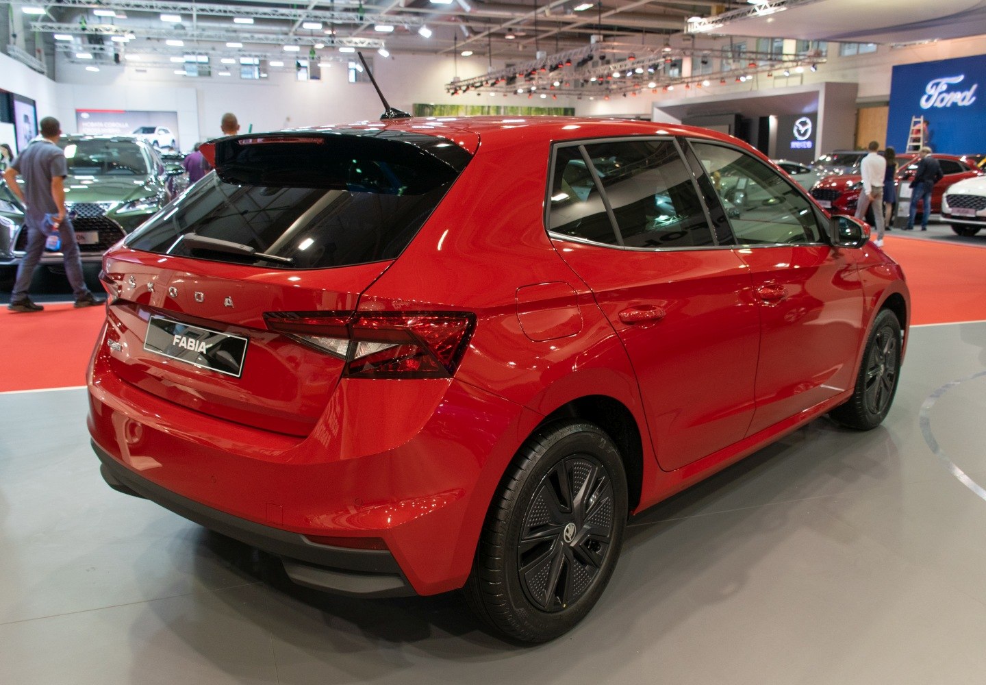 Modern red compact hatchback rear and side profile with tinted windows