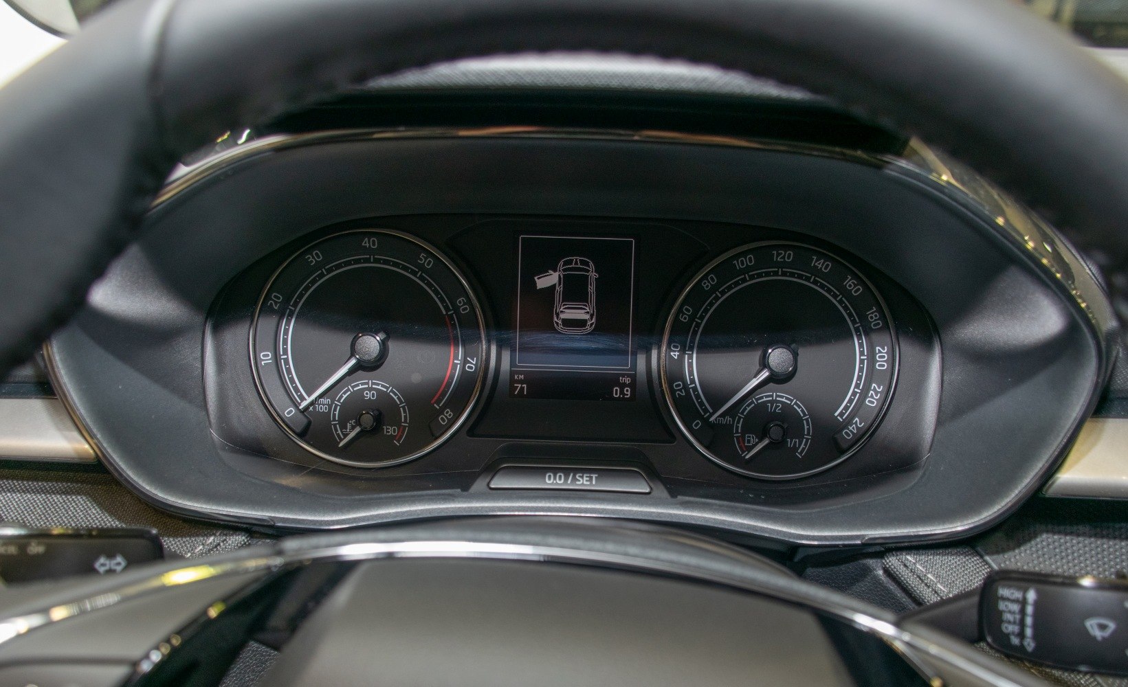 Dashboard with analog tachometer, speedometer, and digital car status screen