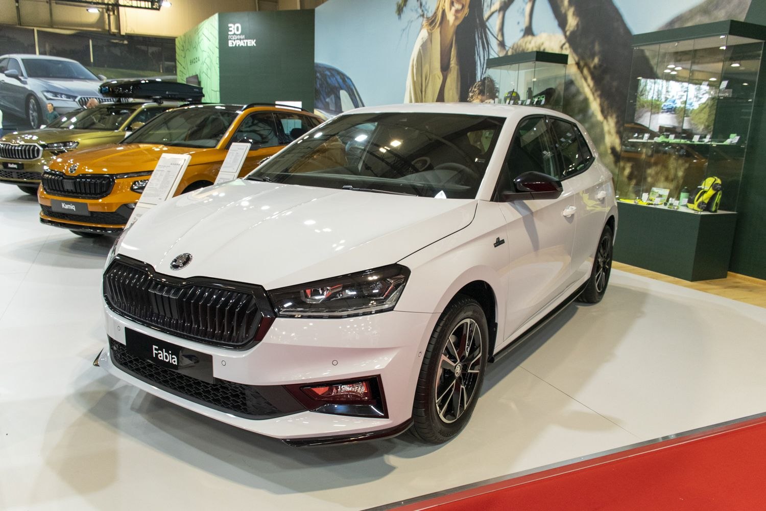 White hatchback with black grille and alloy wheels front view