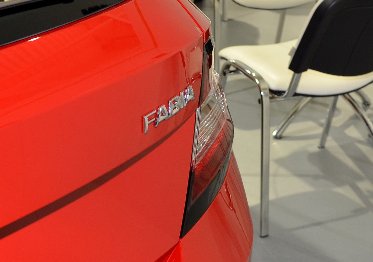 Close-up of rear badge and taillight of a red hatchback