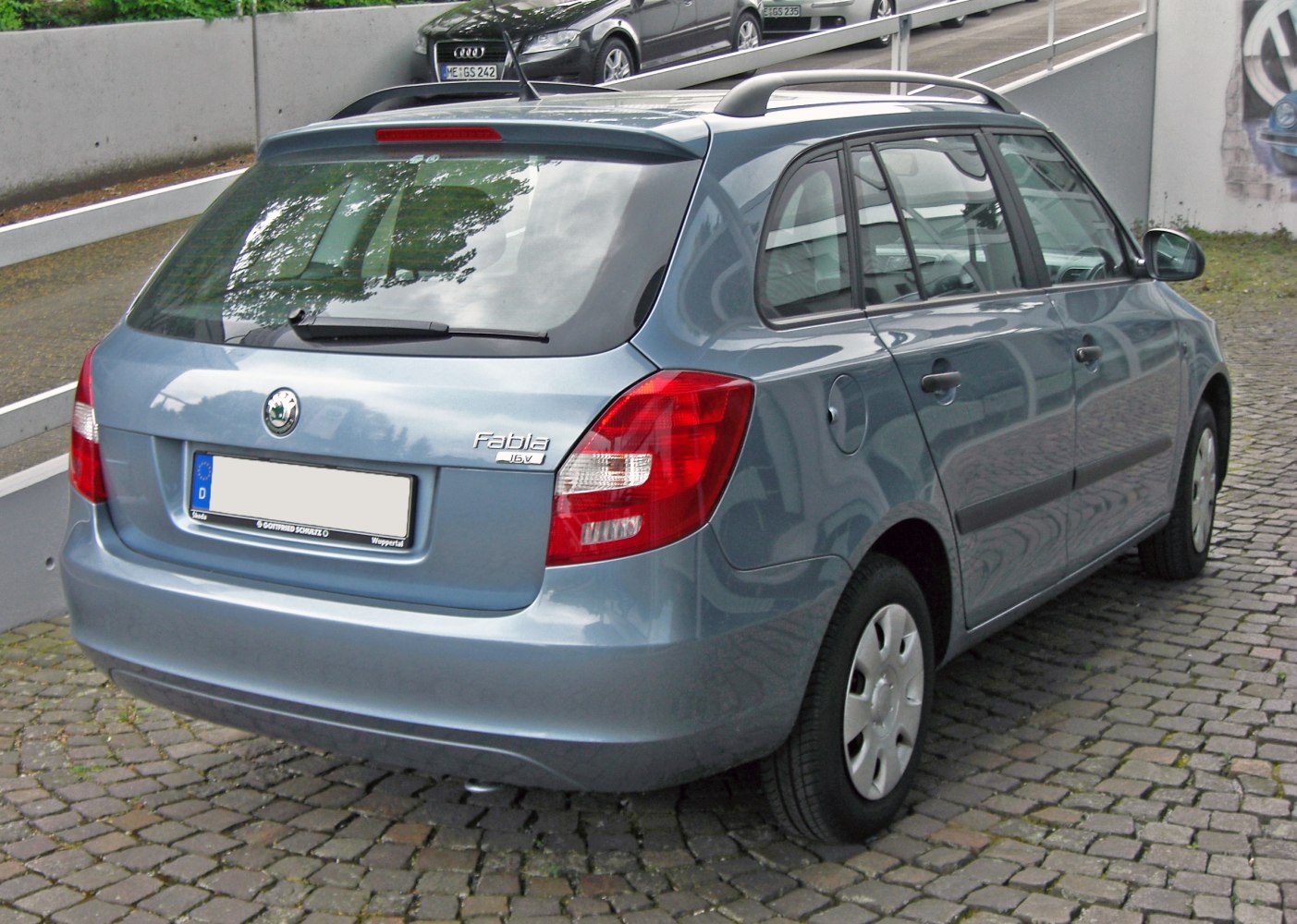 Rear and side view of a compact station wagon with roof rails