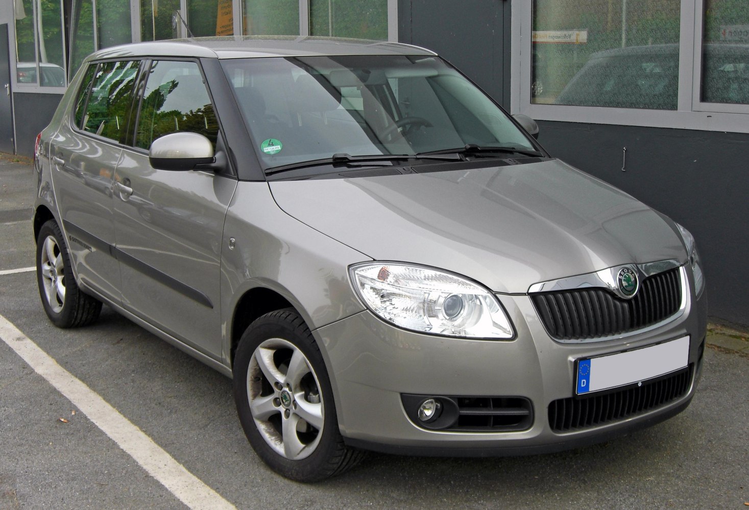 Front grille, headlight, and passenger side profile of compact hatchback
