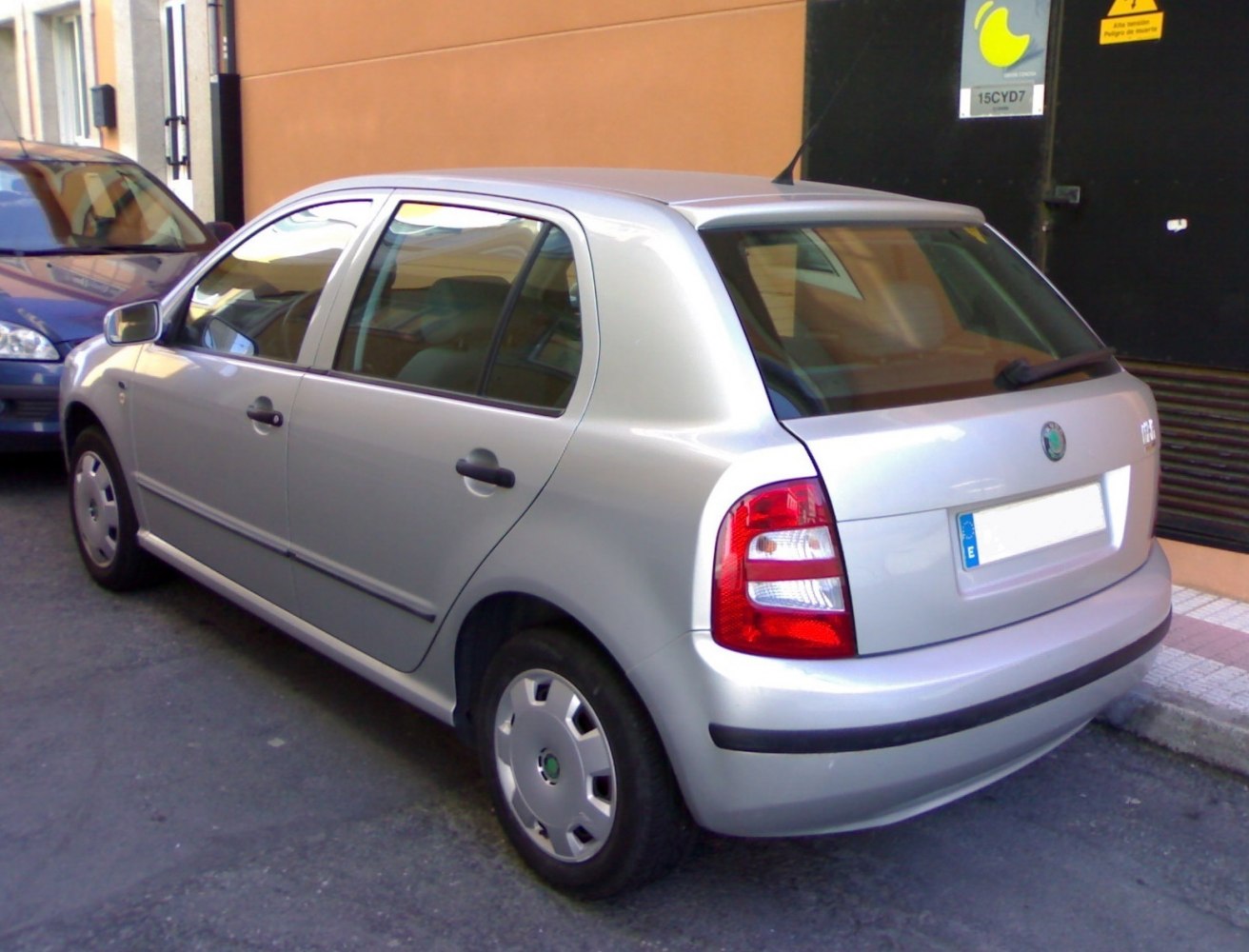 Silver 5-door hatchback rear side with tail lights visible