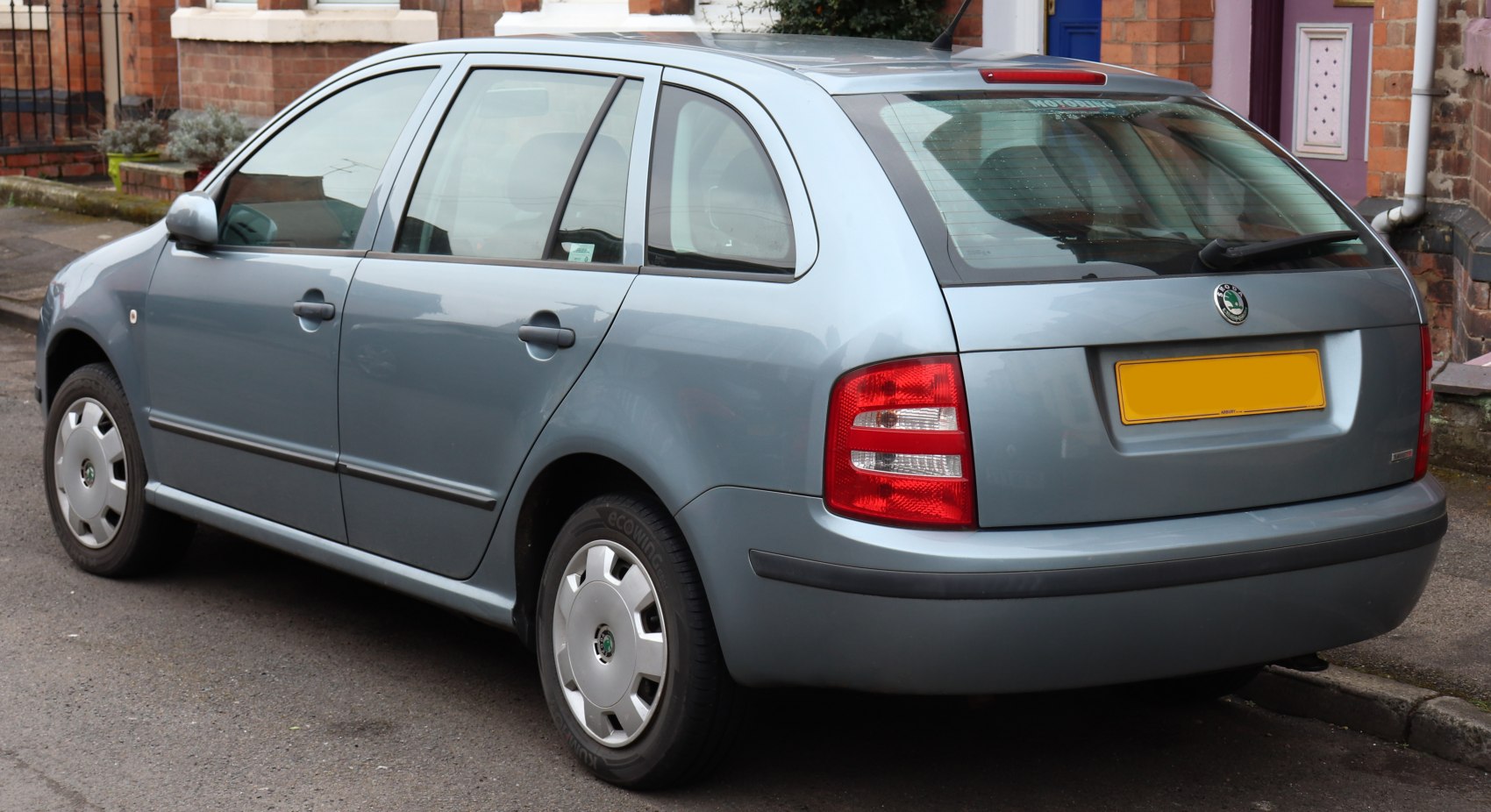 Rear side view of compact station wagon with distinct taillights and hatchback