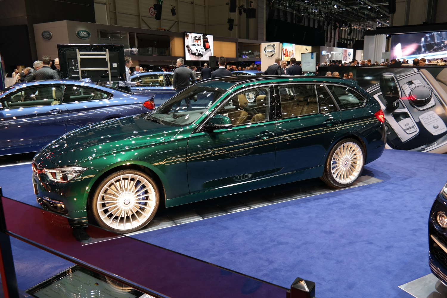 Dark green estate car with classic multi-spoke wheels and sporty styling