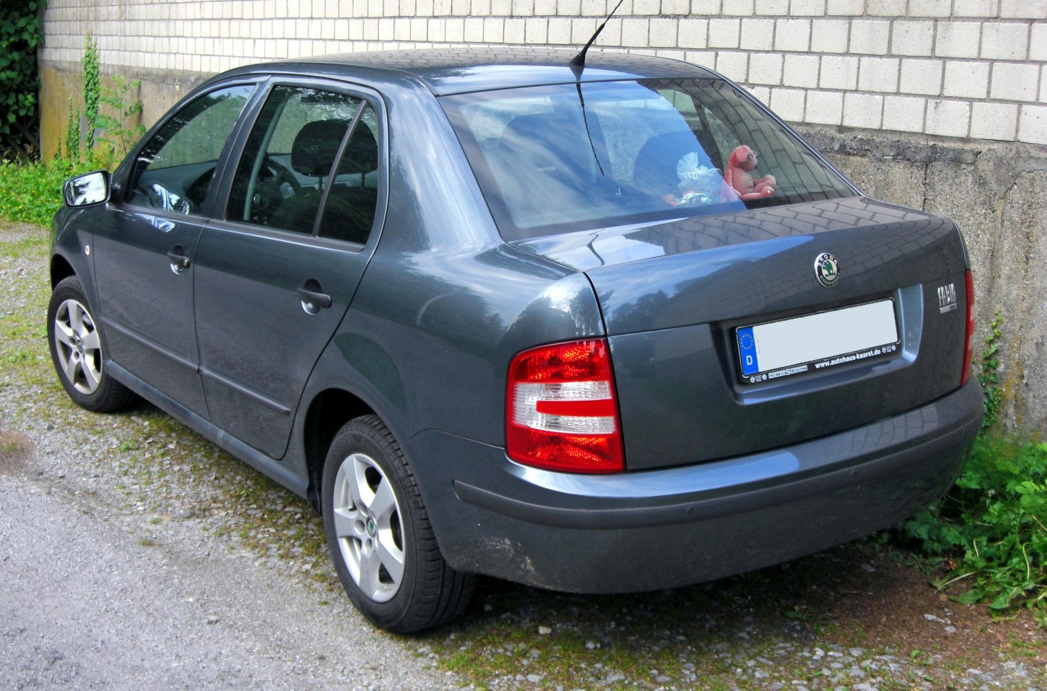 Rear view with taillights and four-door compact sedan body