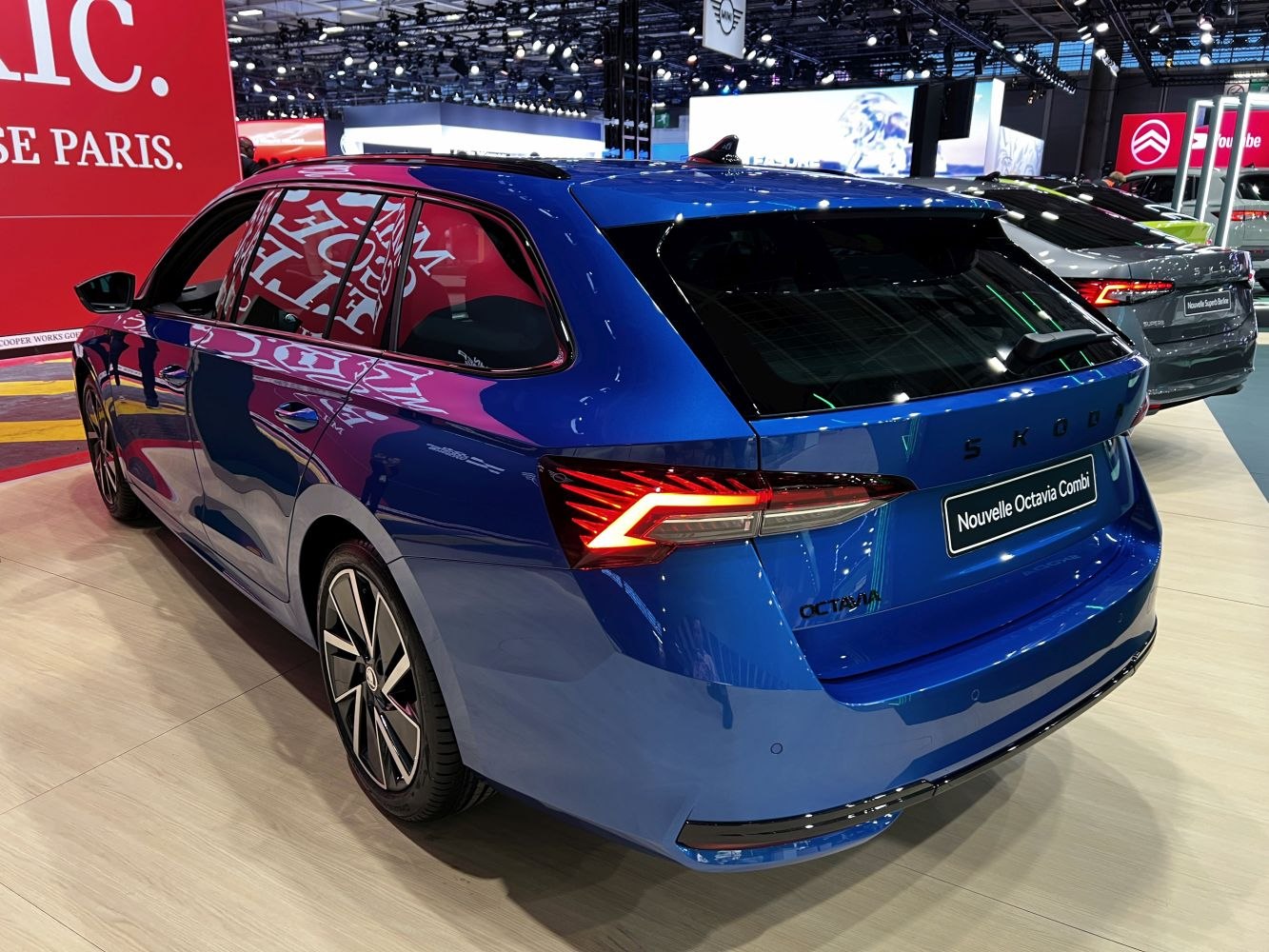Rear view of a blue station wagon with modern LED tail lights and stylish alloy wheels.