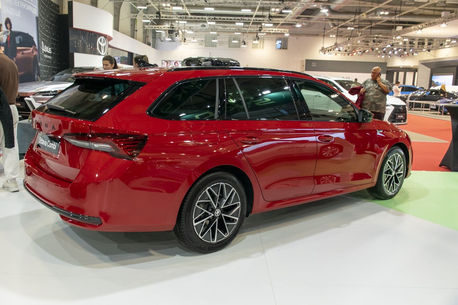 Rear side view of a red station wagon with modern alloy wheels