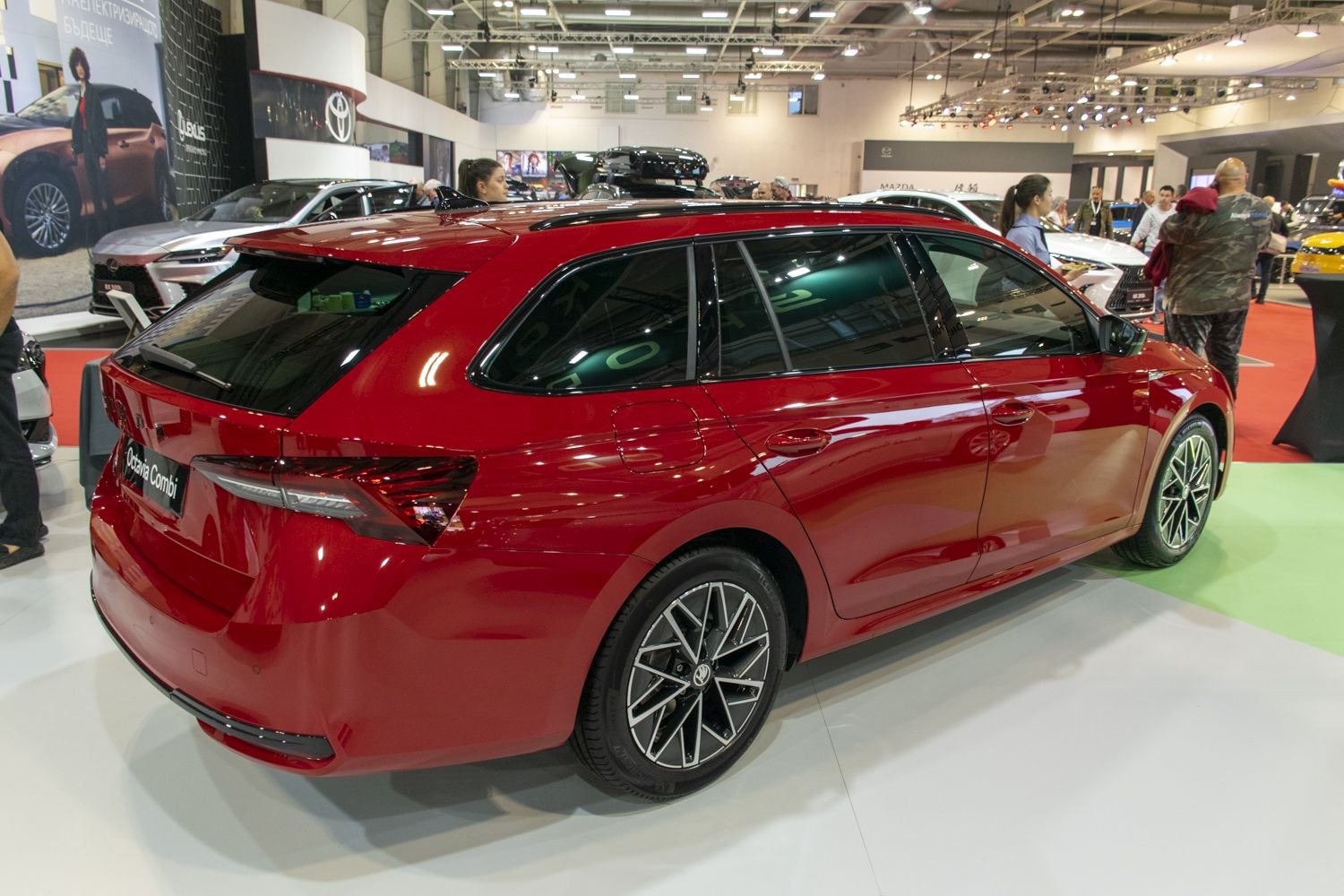 Sleek rear three-quarter view of a red station wagon with tinted windows and alloy wheels