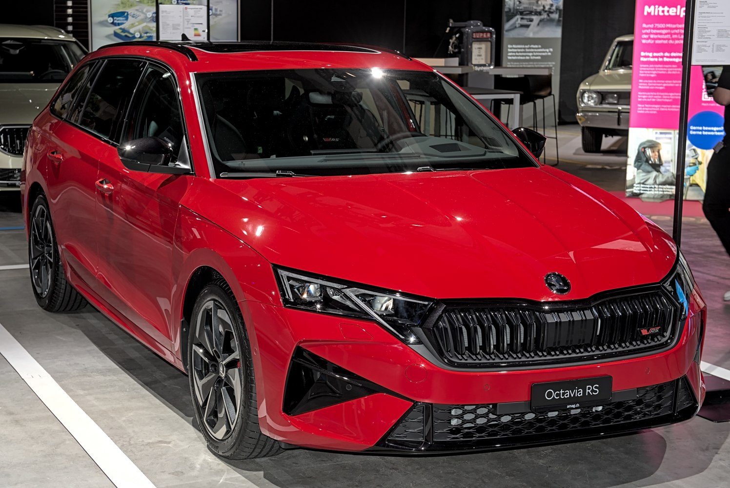 Front view of sporty red station wagon with aggressive grille and sleek headlights