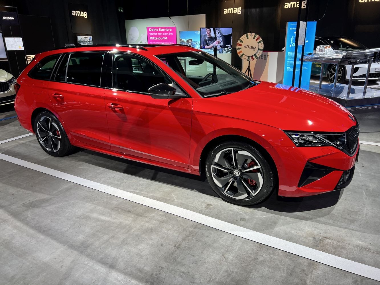 Side profile of red station wagon with sporty alloy wheels
