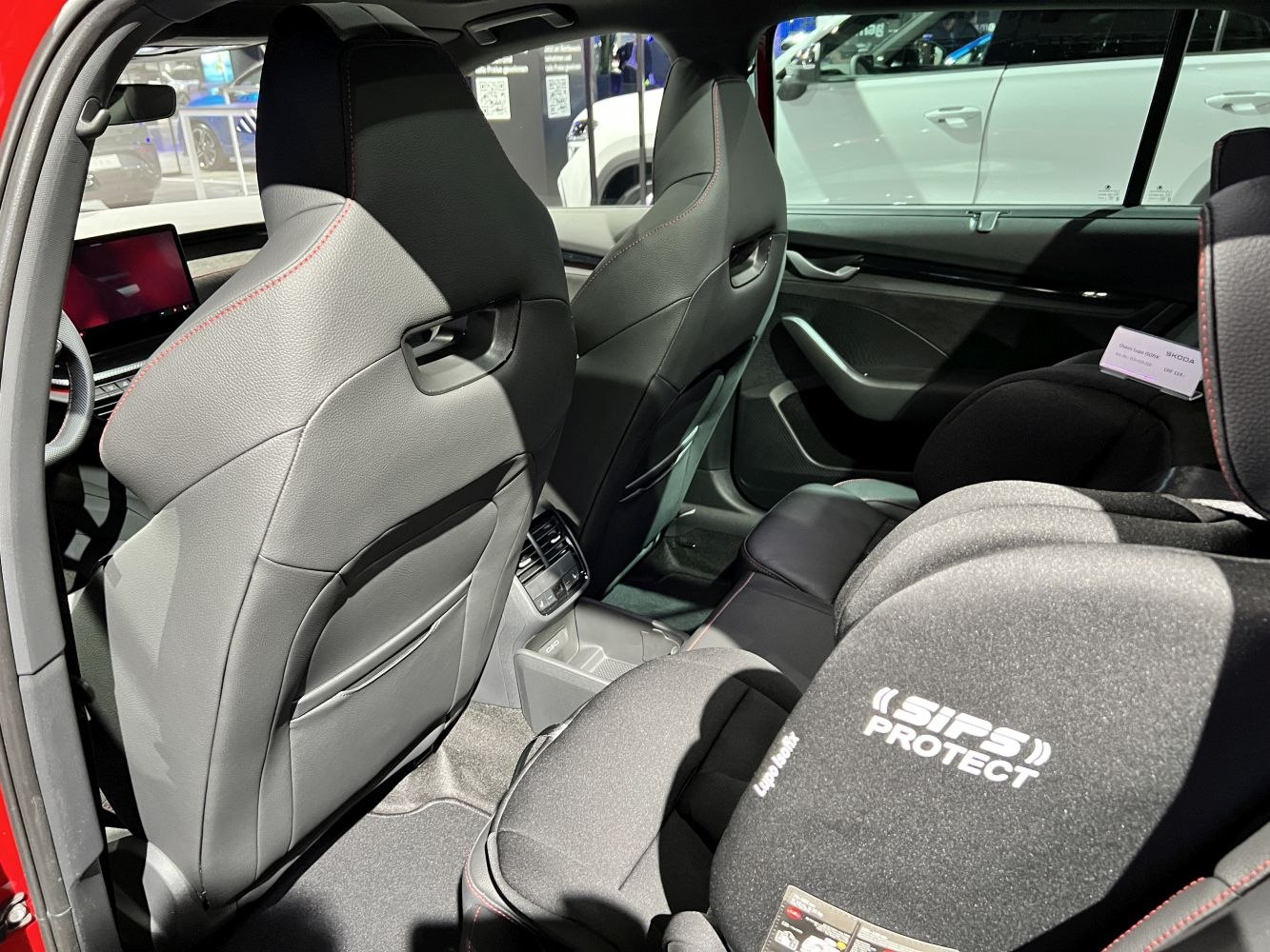 Rear interior seating with child safety seat and detailed upholstery