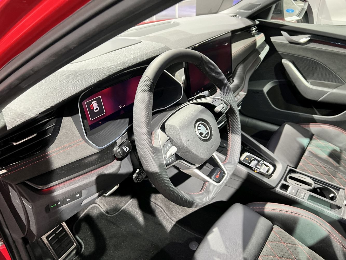 Digital cockpit and multifunction steering wheel in a modern car interior.