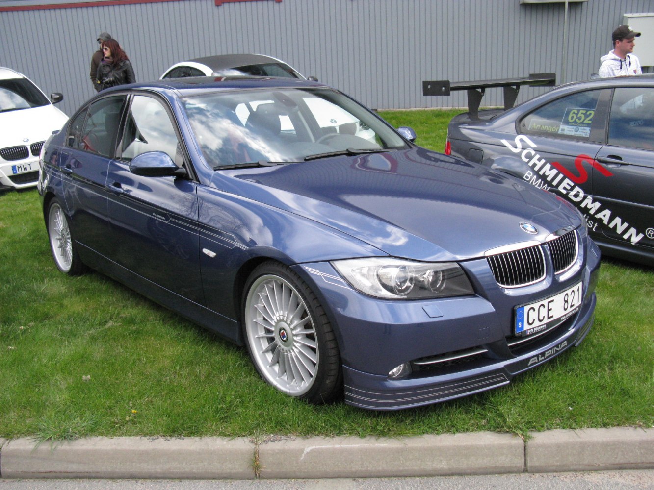 Front side view of a sporty sedan with Alpina wheels and aerodynamic front lip