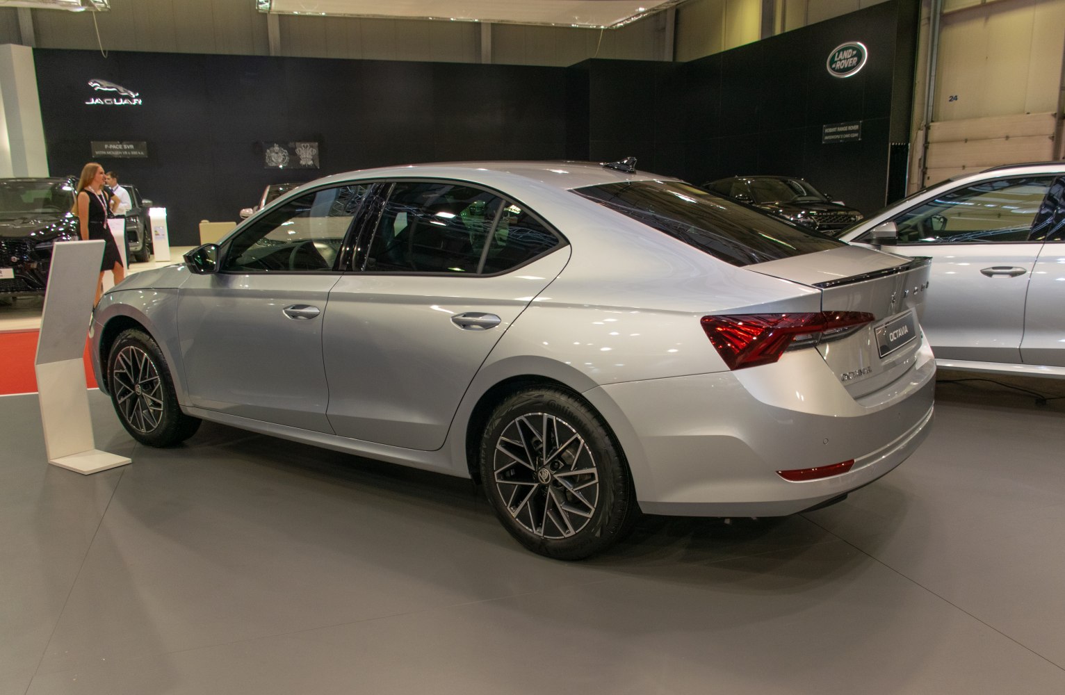 Rear and side view of modern sedan with alloy wheels and sharp tail lights