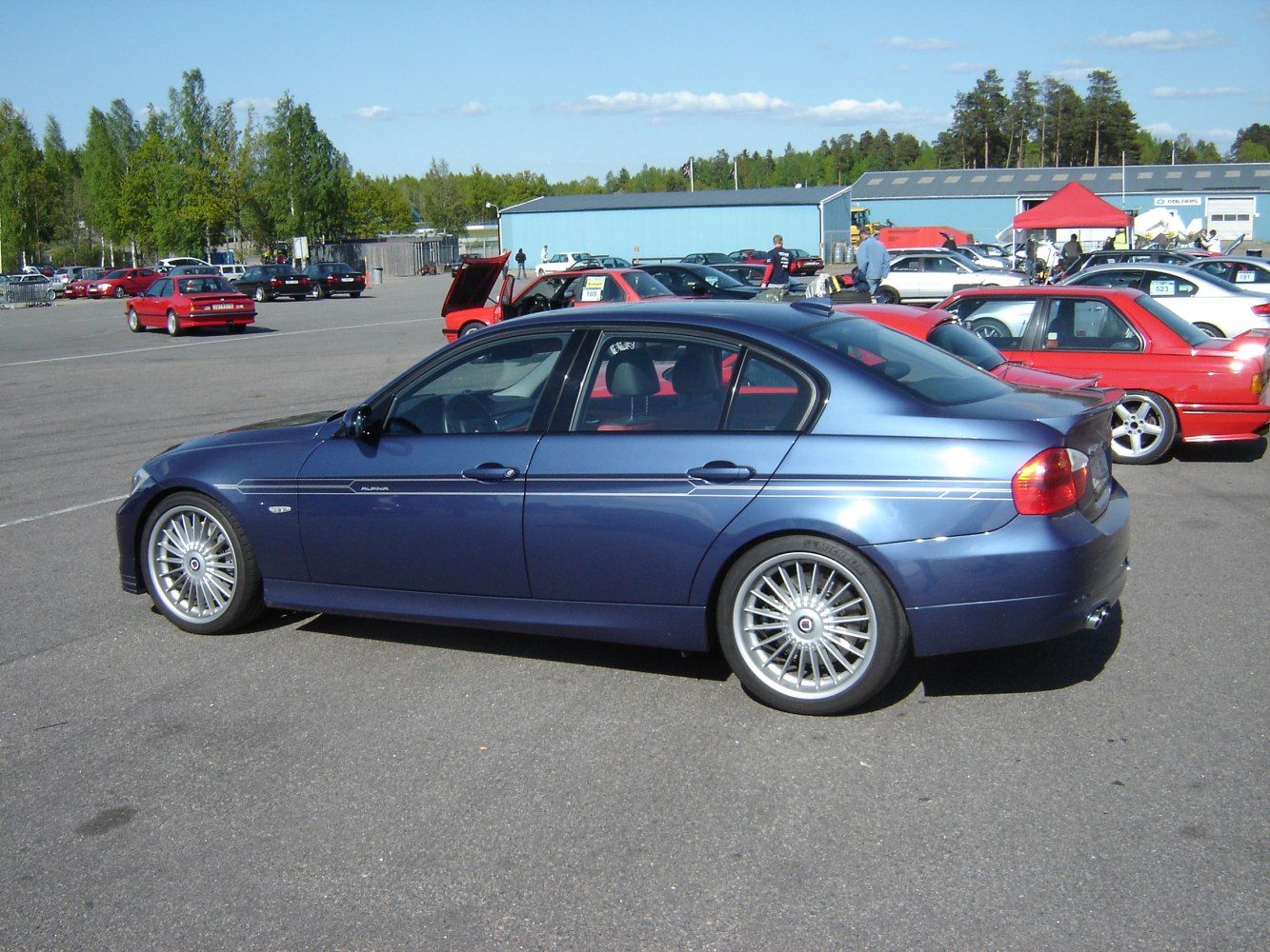Side profile of luxury sedan with Alpina multi-spoke wheels and signature decals