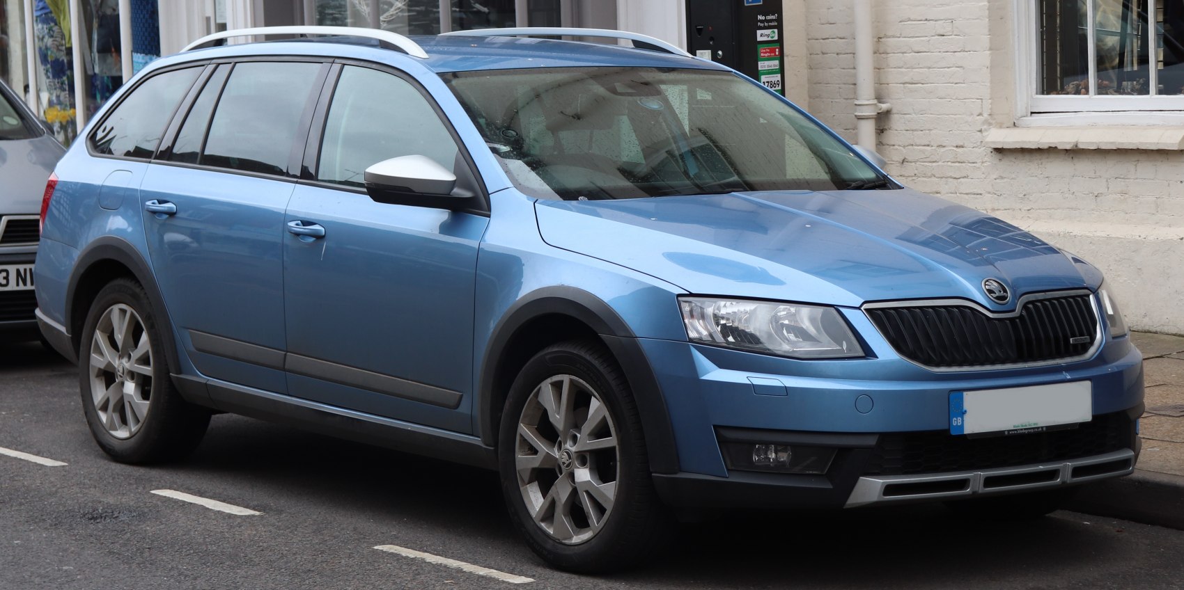 Blue off-road style wagon with roof rails and black fender flares