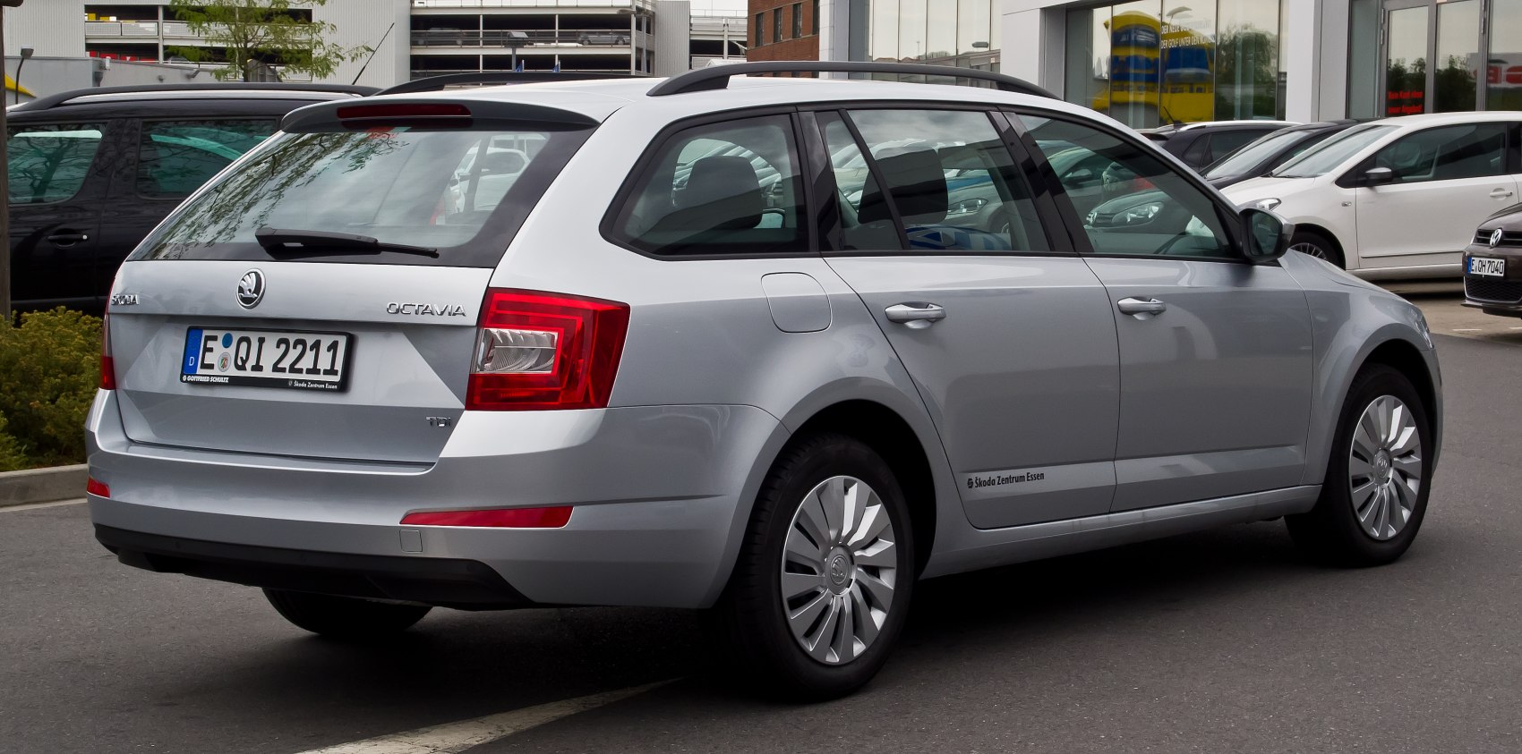 Rear and side view of silver station wagon with roof rails