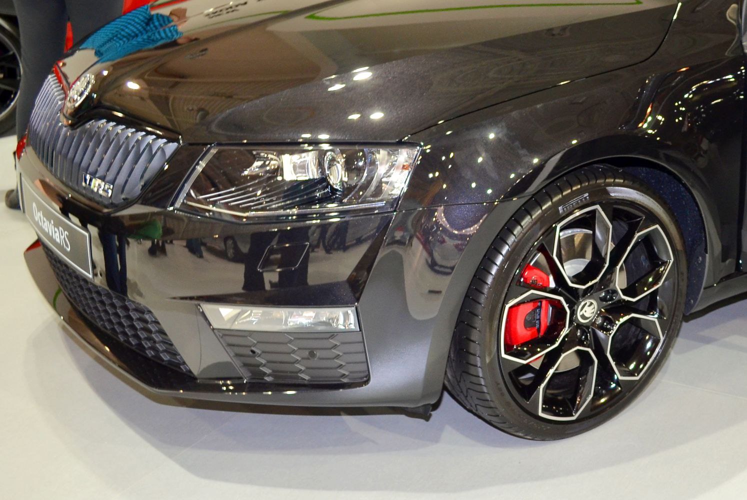 Front grille, headlight, and alloy wheel with red brake caliper