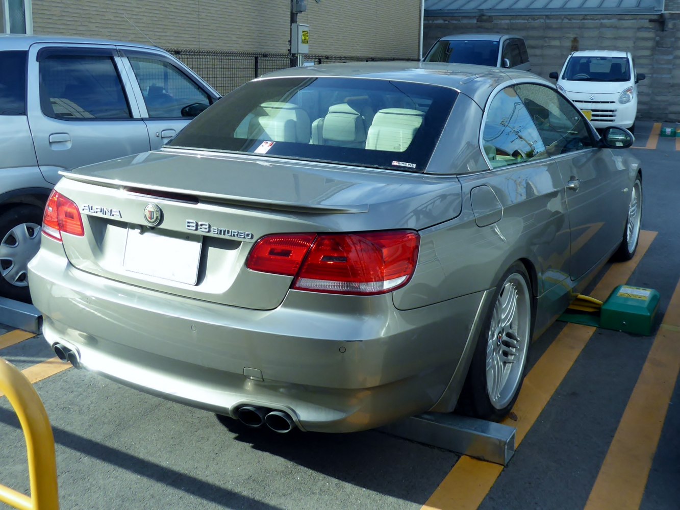 Rear view with quad exhaust tips, rear spoiler, and BBS alloy wheels