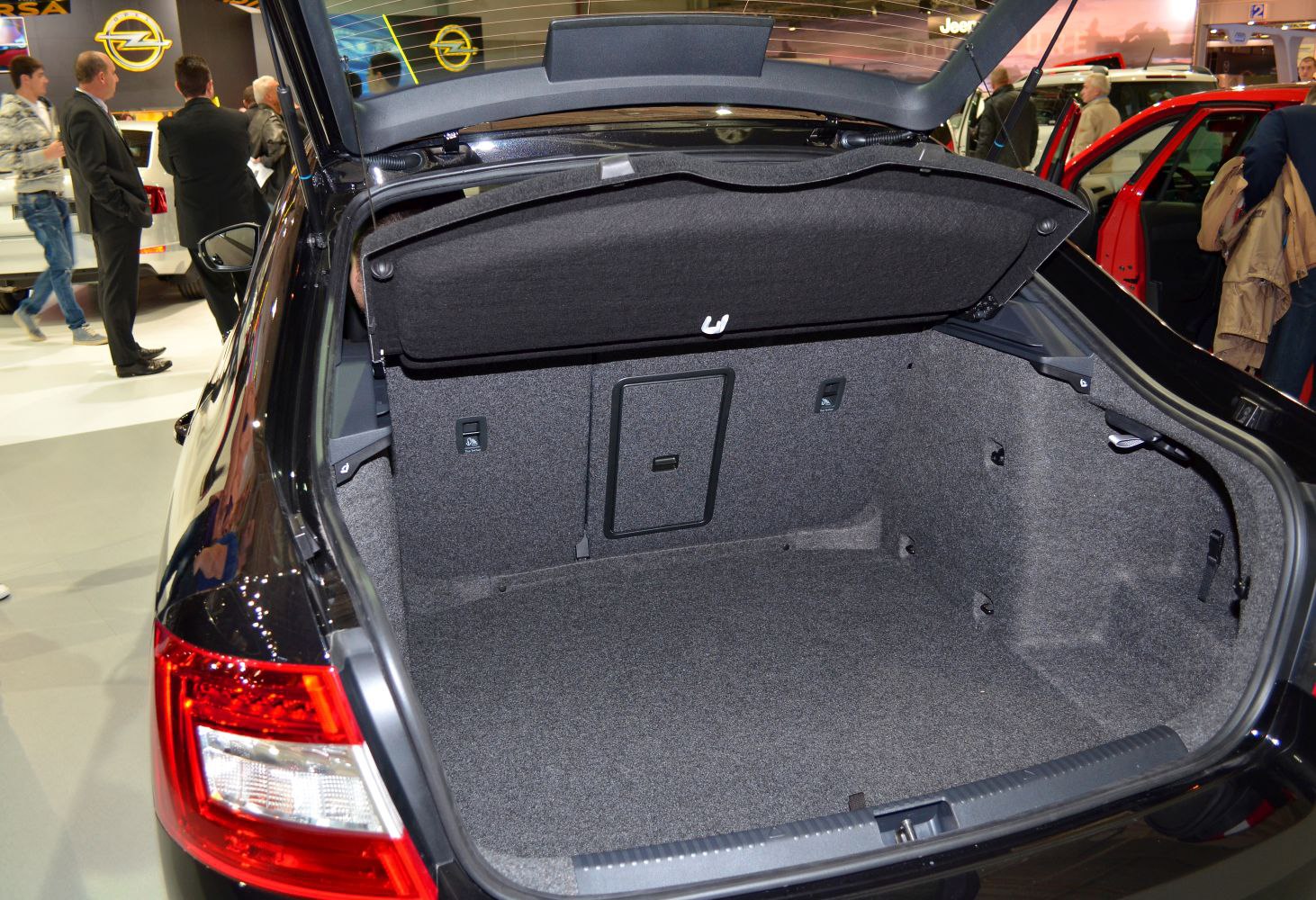 Large, lined, spacious car trunk interior with fold-down rear seat access.