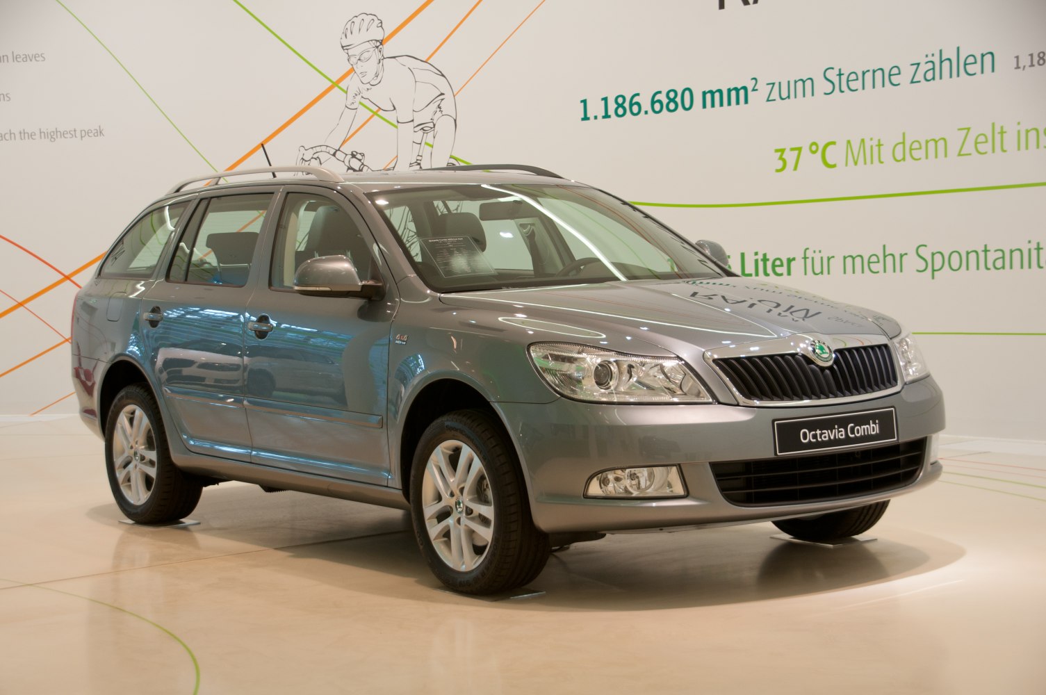 Grey station wagon with roof rails and 4x4 badge shown from front side