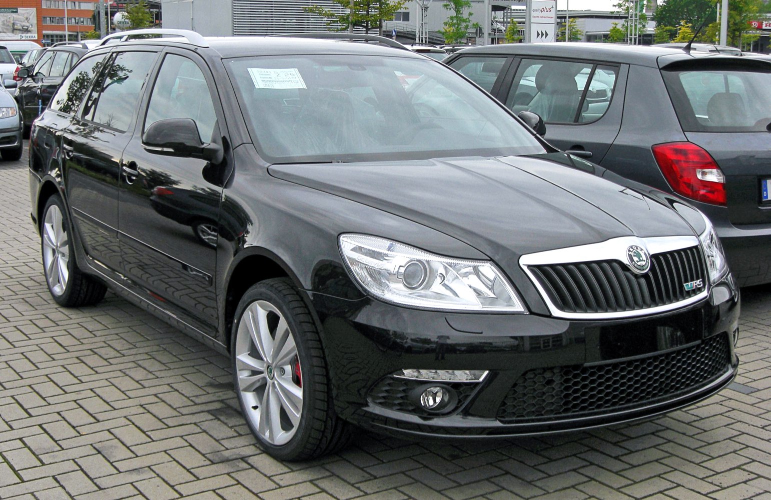 Front and side view of black estate car with distinct grille and alloy wheels