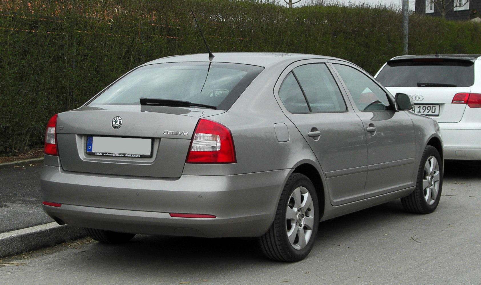 Rear view of sedan with distinctive tail lights and compact rear design.
