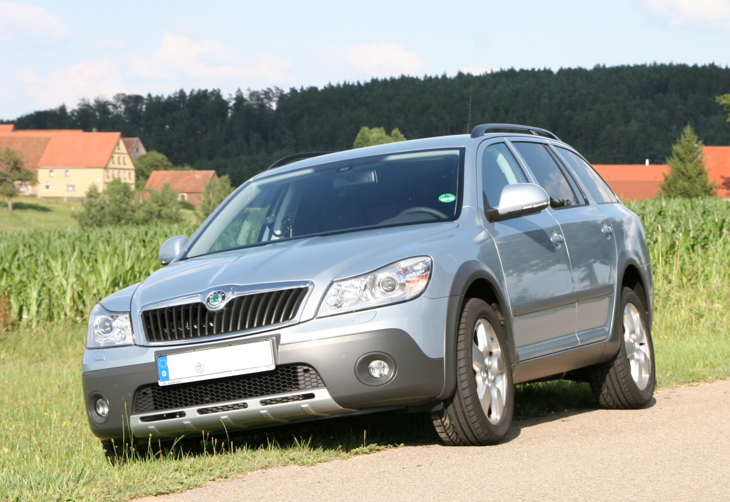 Silver station wagon with front and side view, roof rails, alloy wheels