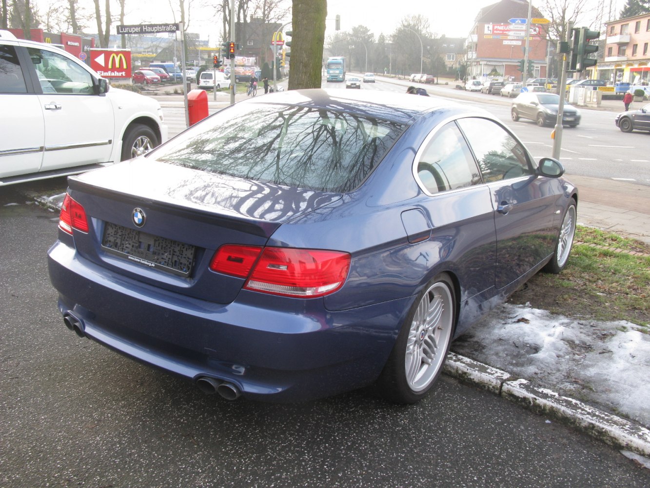 Rear view of a coupe with quad exhaust and alloy wheels