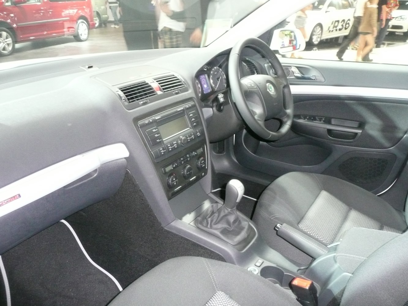 Manual gear shifter and dashboard interior with steering wheel