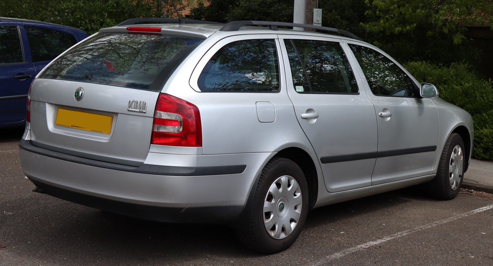 Rear side view of silver station wagon with roof rails