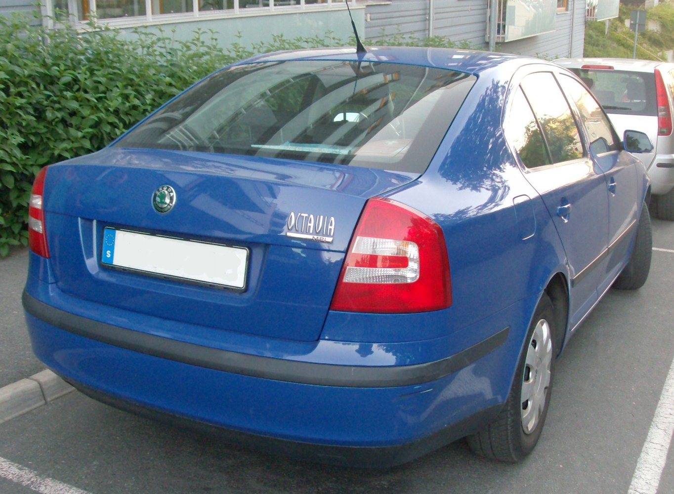 Rear view of blue sedan with unique tail lights and black rear bumper