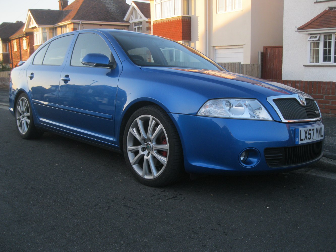 Blue sedan with alloy wheels and clear lens headlights