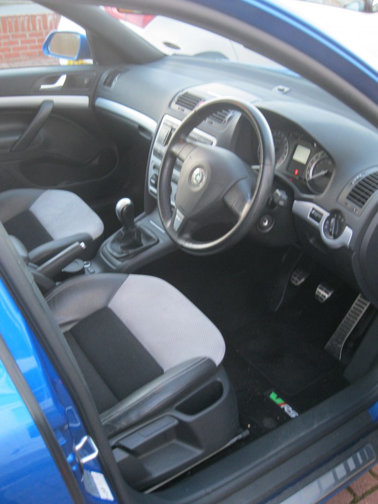 Manual transmission, sporty seats, and sleek dashboard interior.