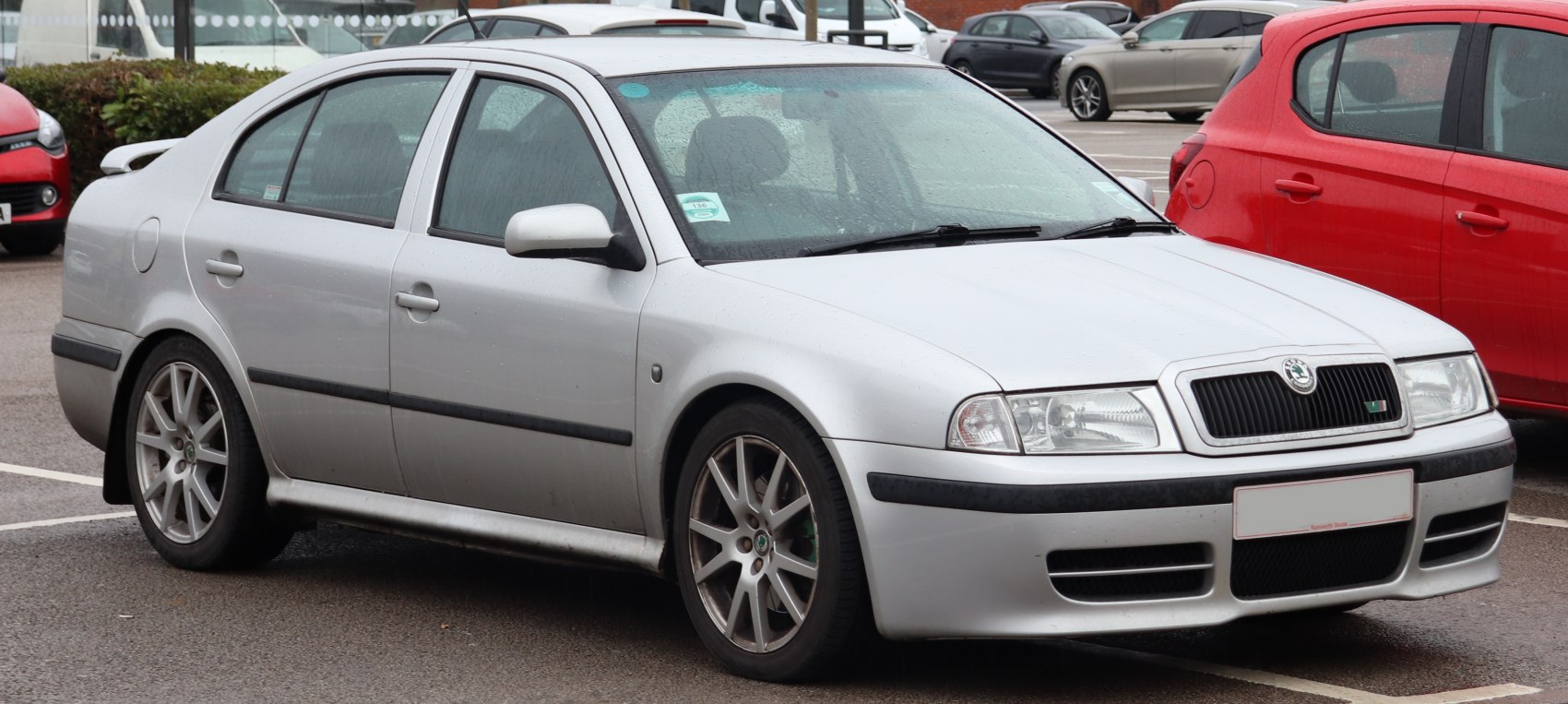 Silver four-door sedan with alloy wheels and black trim