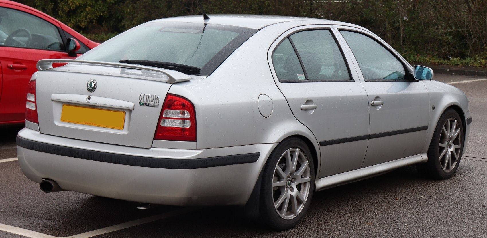 Rear and side profile with rear spoiler and alloy wheels