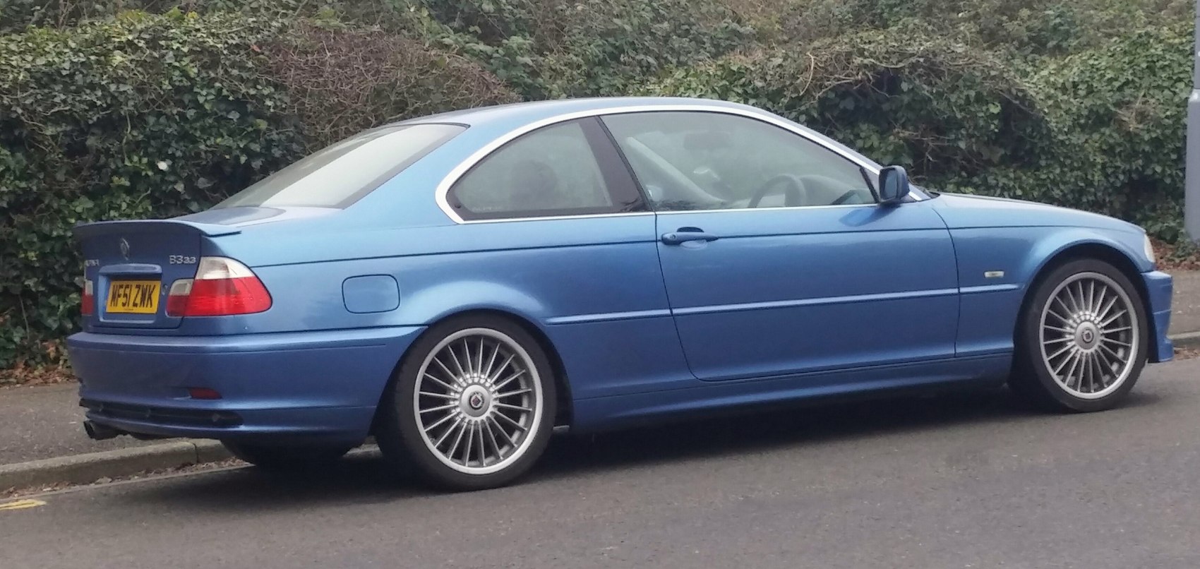 Blue two-door sports coupe with multi-spoke alloy wheels