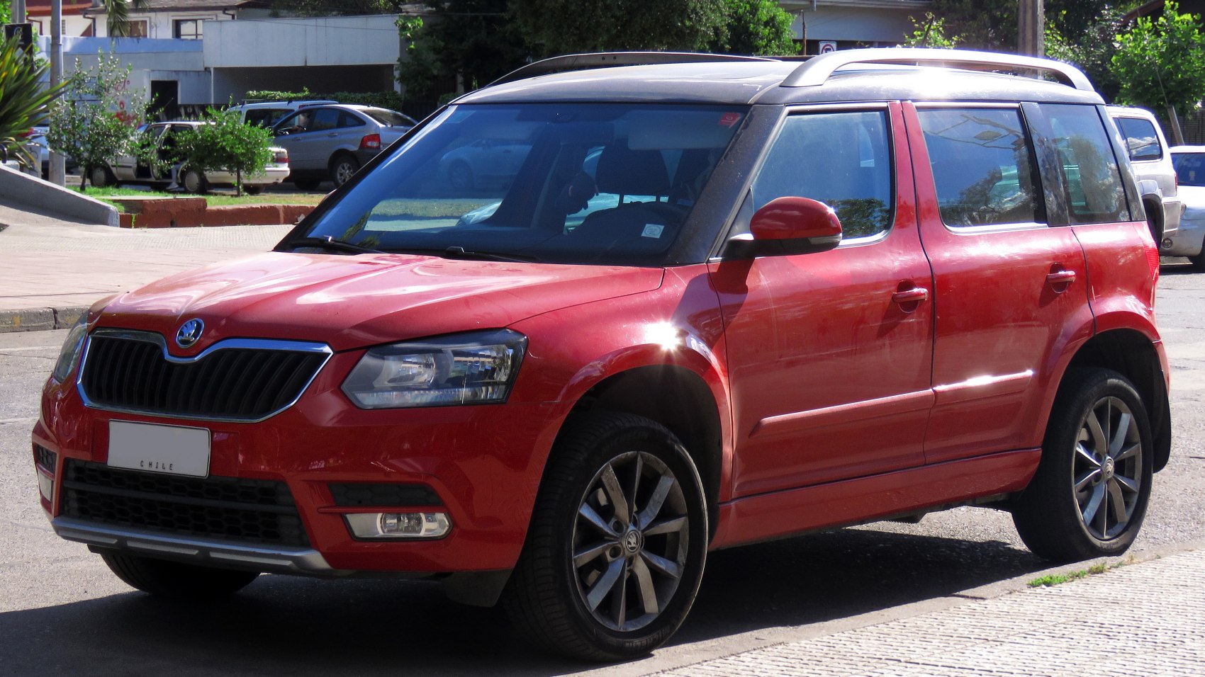 Red compact SUV with roof rails and alloy wheels