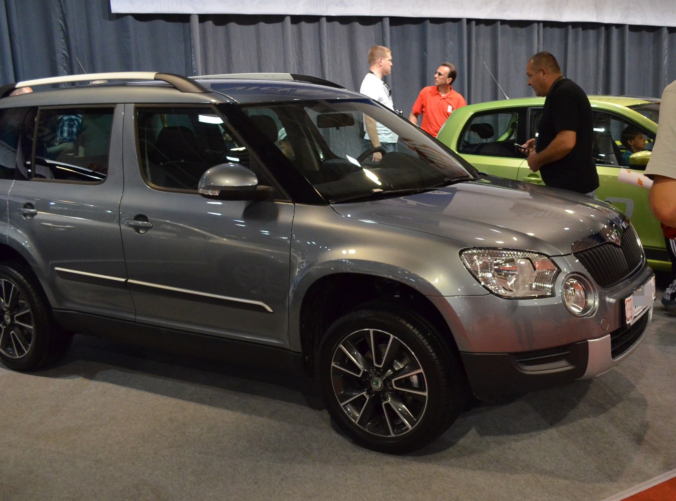 Compact SUV with round headlights and multi-spoke alloy wheels