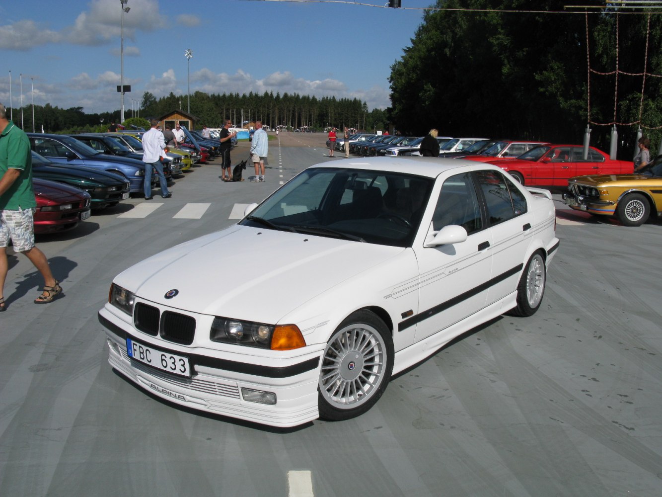 White sedan with Alpina front spoiler, signature wheels, and side decals