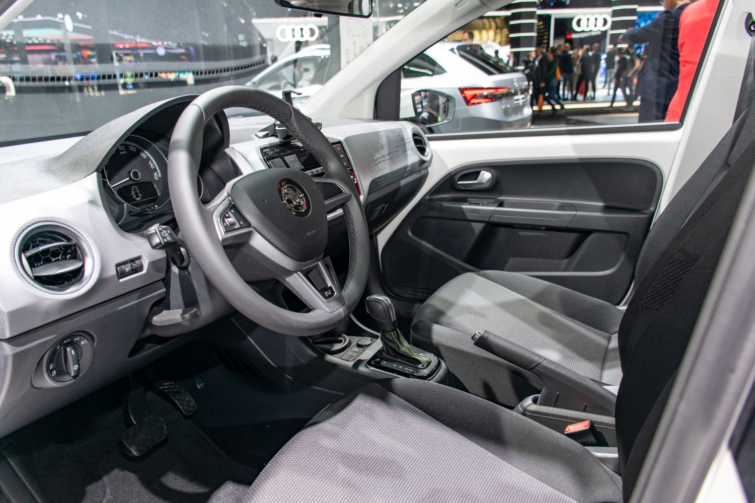 Dashboard, steering wheel, and front seats of a compact car interior