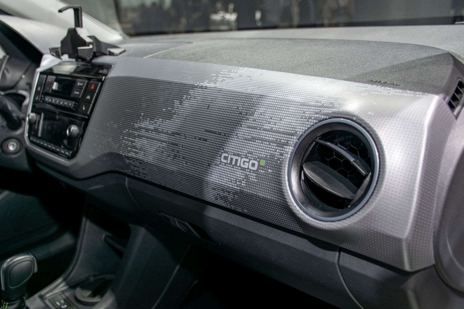 Dashboard with textured pattern and round air vent.
