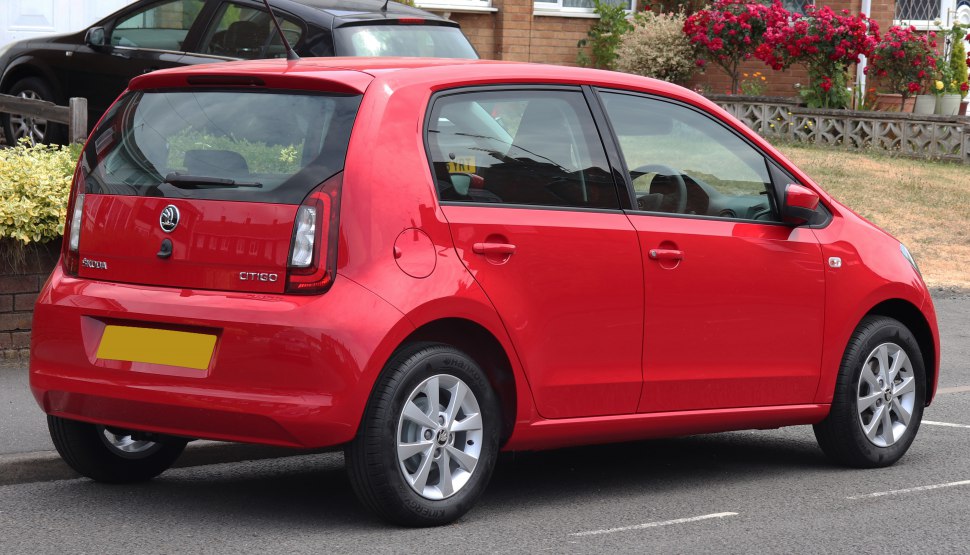 Red 5-door compact hatchback showing rear and side view.