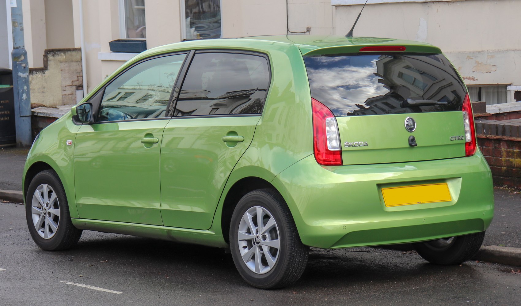 Green 5-door compact hatchback rear side with alloy wheels and vertical tail lights
