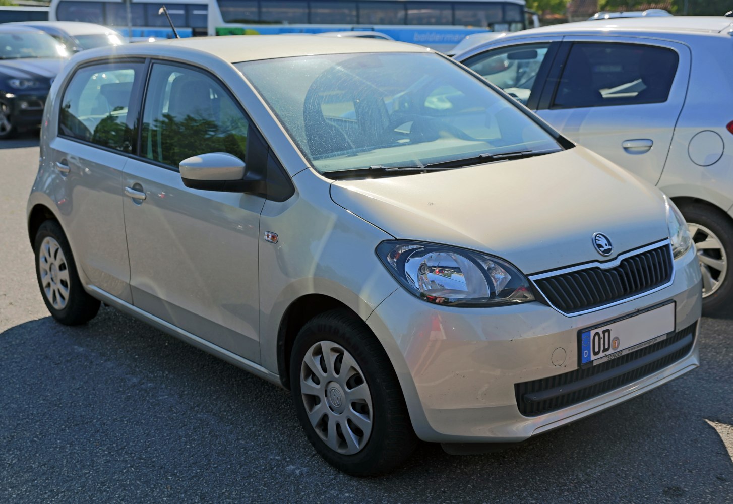 Compact 5-door hatchback front and side view with hubcap wheels
