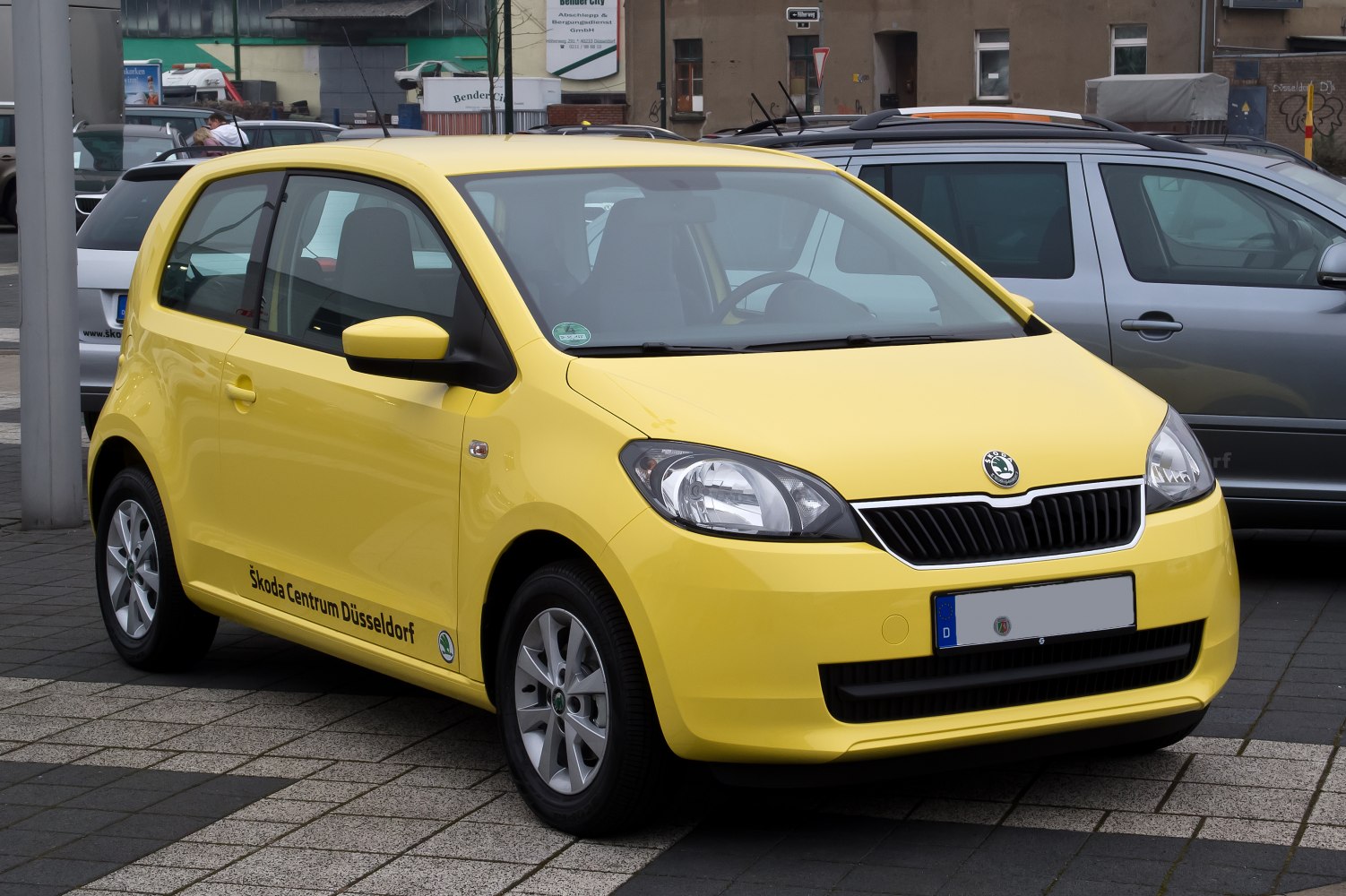 Yellow 3-door compact hatchback with modern headlights and front grille