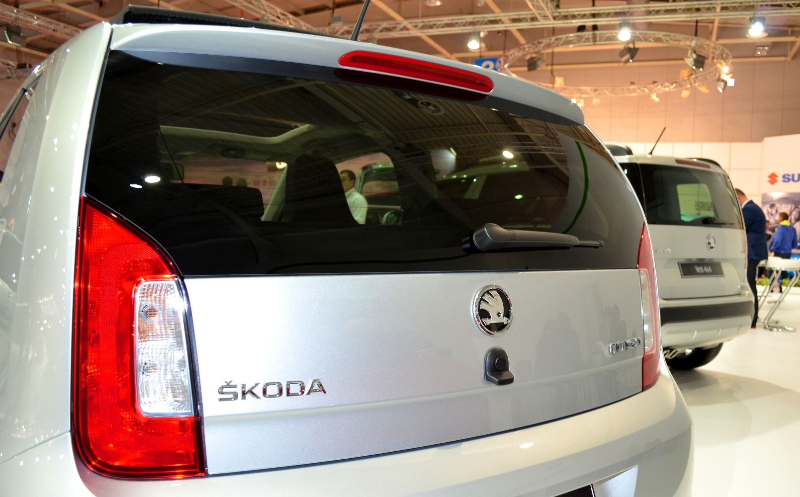 Rear view with badge, tail light, and rear wiper on small hatchback