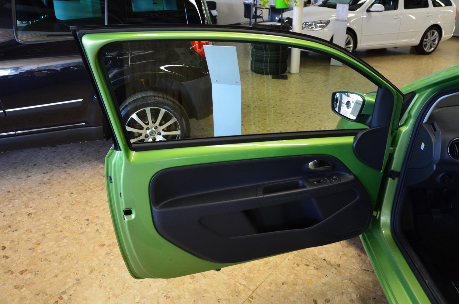 Interior view of a car's 3-door side door with window and door handle